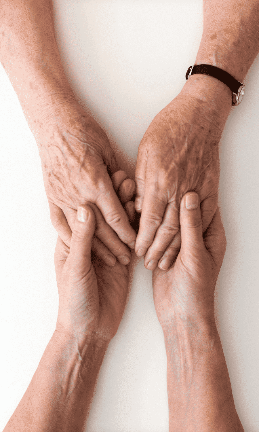 Young person holding hands with senior closeup